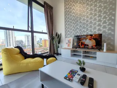 a living room with a yellow chair and a tv at SoftGrey 2 Rooms Apartment, 4 plus 2 Pax at Urban Suites in Jelutong