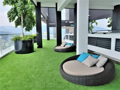 a balcony with two bean chairs on a green lawn at SoftGrey 2 Rooms Apartment, 4 plus 2 Pax at Urban Suites in Jelutong