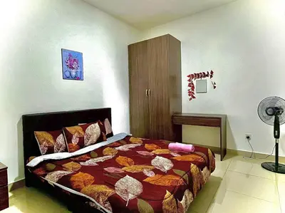 a bedroom with a bed and a fan at Ammara Homestay 2 Palas Horizon Kea Farm in Cameron Highlands