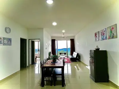 a living room with a table and a kitchen at Ammara Homestay 2 Palas Horizon Kea Farm in Cameron Highlands