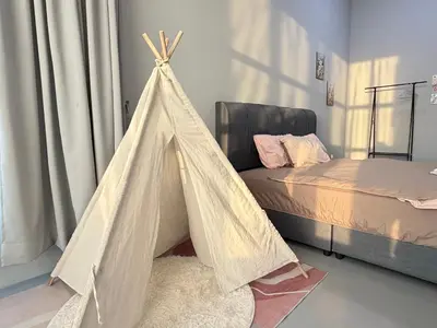 a bedroom with a bed and a teepee tent at KB Penang Guest House1-8pax in Kepala Batas