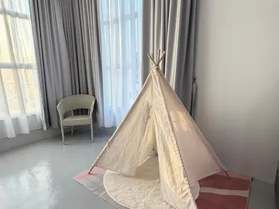 a tent in a room with a chair and windows at KB Penang Guest House1-8pax in Kepala Batas