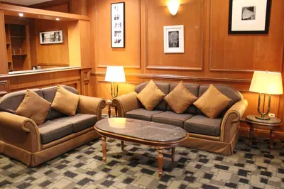 a living room with two couches and a coffee table at Cinta Sayang Resort in Sungai Petani