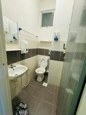 a bathroom with a toilet and a sink at AYAAN SYMPHONY INN Budget Homestay with Free WiFi and Netflix in Tanah Rata