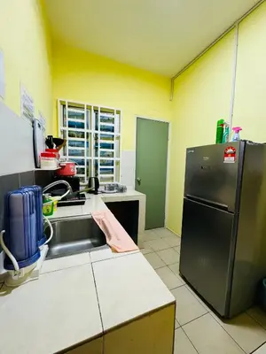 a kitchen with a stainless steel refrigerator and a sink at AYAAN SYMPHONY INN Budget Homestay with Free WiFi and Netflix in Tanah Rata