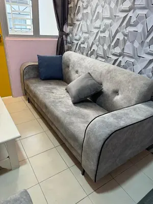 a couch with two pillows on it in a room at AYAAN SYMPHONY INN Budget Homestay with Free WiFi and Netflix in Tanah Rata