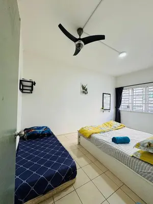 a bedroom with two beds and a ceiling fan at AYAAN SYMPHONY INN Budget Homestay with Free WiFi and Netflix in Tanah Rata