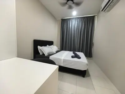 a hotel room with two beds and a chair at Ipoh Town 2224 six pax By Hopestay in Ipoh