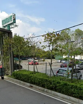 a gas station with cars parked in a parking lot at SweeT Homestay in Perai