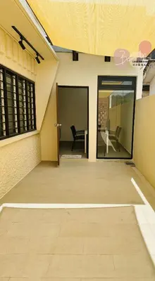 an empty patio with a glass door and a chair at Little Homestay Two - \u5c0f\u5c0f\u6c11\u5bbf2 in Ipoh