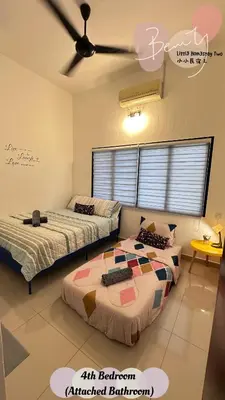 two beds in a room with a ceiling fan at Little Homestay Two - \u5c0f\u5c0f\u6c11\u5bbf2 in Ipoh