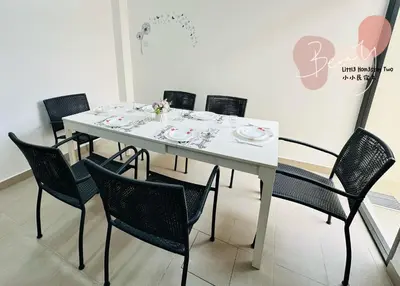 a white table with chairs and plates on it at Little Homestay Two - \u5c0f\u5c0f\u6c11\u5bbf2 in Ipoh