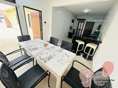 a dining room with a white table and chairs at Little Homestay Two - \u5c0f\u5c0f\u6c11\u5bbf2 in Ipoh