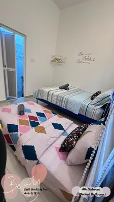 a bedroom with two beds and a quilt at Little Homestay Two - \u5c0f\u5c0f\u6c11\u5bbf2 in Ipoh