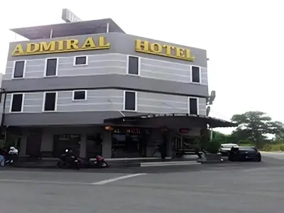 a hotel with motorcycles parked in front of it at Admiral Hotel in Kampong Lumut Kiri