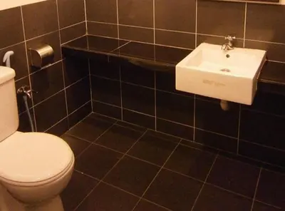a bathroom with a white toilet and a sink at Hotel Kawan in Tapah