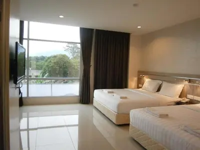 a hotel room with two beds and a large window at Hotel Kawan in Tapah