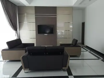 a living room with two couches and a tv at LF Hotel Tapah in Tapah