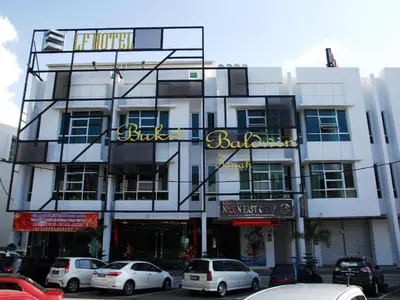 a building with cars parked in front of it at LF Hotel Tapah in Tapah