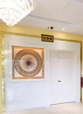 a room with a chandelier and a painting on the wall at Pice Hotel in Kampong Permatang Batu