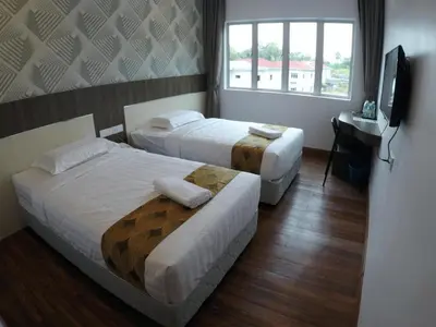 a hotel room with two beds and a television at HOTEL KAWAN BIDOR in Bidur
