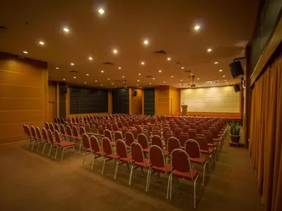 an empty auditorium with red chairs in a building at Hotel Continental Penang in George Town