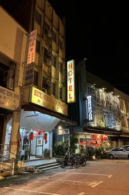 two motorcycles parked in front of a building at night at Sun Golden Inn in Ipoh