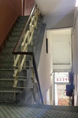 a wooden staircase in a building with a window at Sun Golden Inn in Ipoh