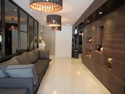a living room with a couch and two chandeliers at Mornington Hotel Soon Choon Ipoh in Kampong Sengat