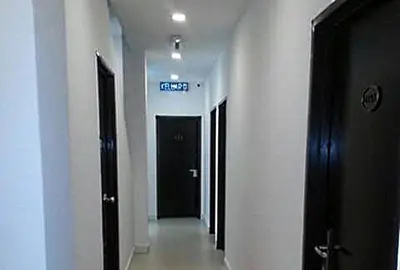 a hallway of a building with a sign on the wall at D Nice Hotel in Relau