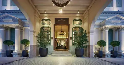 a lobby with a entrance to a building with potted plants at The Edison George Town in George Town