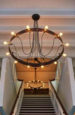 a large chandelier in a building with a staircase at The Edison George Town in George Town