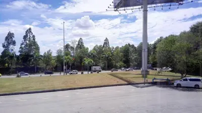 a parking lot with cars parked in a park at SP Golden Star Hotel in Kampong Tongka