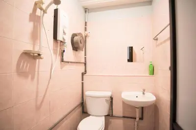a bathroom with a toilet and a sink at Ipoh Sakura Hotel in Ipoh