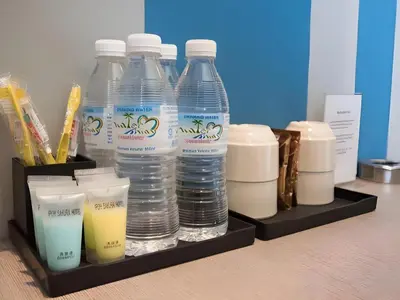 a group of bottles of water on a shelf at Ipoh Sakura Hotel in Ipoh