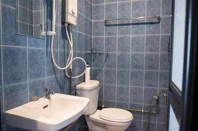 a bathroom with a toilet and a sink at Ipoh Sakura Hotel in Ipoh
