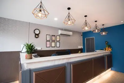 a bar in a room with blue walls and pendant lights at Ipoh Sakura Hotel in Ipoh