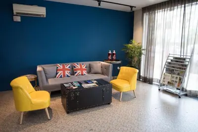 a living room with a couch and two chairs at Ipoh Sakura Hotel in Ipoh