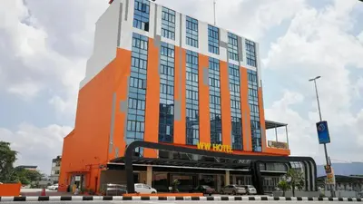 an orange and white building with a bus in front of it at WW Hotel Ipoh in Ipoh