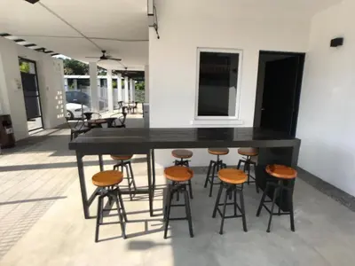 a large black bar with stools and a counter at Kinta Valley Retreat in Kampong Tamboh
