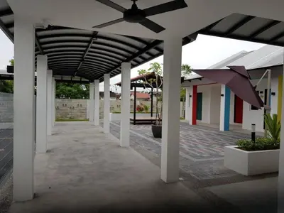 a building with a roof with a ceiling fan at Kinta Valley Retreat in Kampong Tamboh