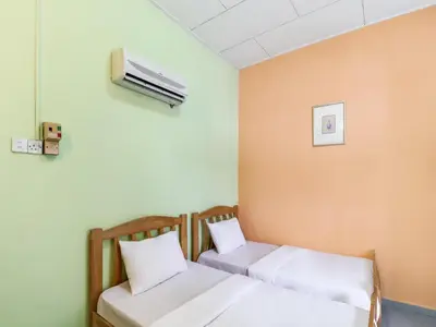 a hospital room with two beds and a air conditioner at OYO 89584 Hotel Sahara Kuala Kubu Bharu in Kuala Kubu Baharu