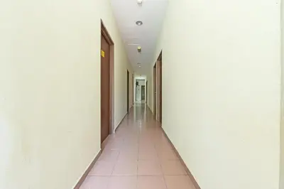 an empty hallway with white walls and a tile floor at SPOT ON 91178 Motel Impian in Seri Manjung