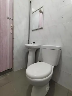 a bathroom with a white toilet and a sink at SPOT ON 89865 Hotel Titiwangsa GM in Gua Musang