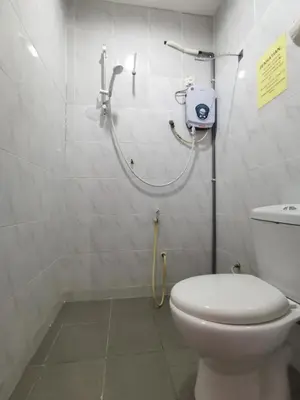 a bathroom with a toilet and a walk in shower at SPOT ON 89865 Hotel Titiwangsa GM in Gua Musang