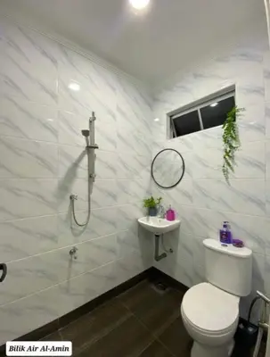 a white bathroom with a toilet and a shower at OYO Home 90711 9 Roses Villa in Kampong Sahum
