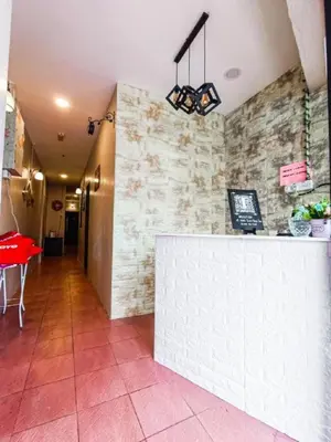 a restaurant with a counter and a red table at The Hotel Tudor Inn in Brinchang