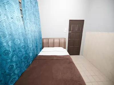 a small room with a bed in a bathroom at Hotel O Iman Roomstay Gua Musang in Kampong Keriting