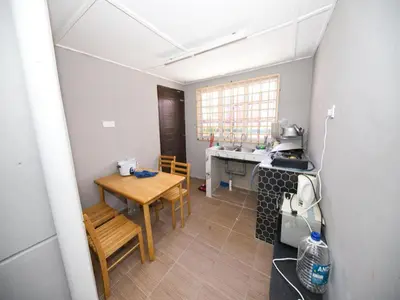 a small kitchen with a table and a table sidx sidx sidx sidx at Hotel O Iman Roomstay Gua Musang in Kampong Keriting