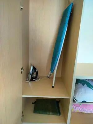 a wooden cabinet with a blue umbrella in it at IFS SoHo Basic Homestay Entire Home in Seri Iskandar